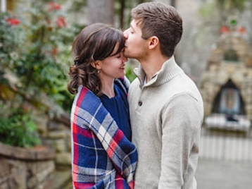 couple-kissing-plaid-blanket-outdoors