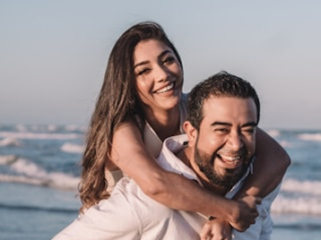 couple-piggyback-beach-sunset